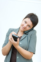 young professional woman with palmtop and phone, on white