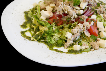 plate of salad isolated on black