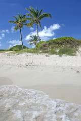 Waves washing up on a beach of the Tobabo Cays.