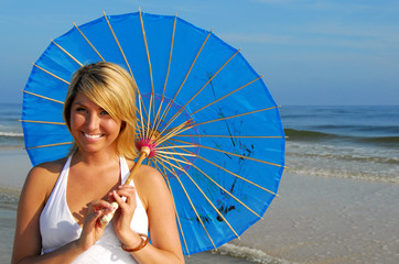 Beautiful woman on pretty beach holding parasol © Cheryl Casey