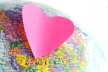 Earth globe and paper heart