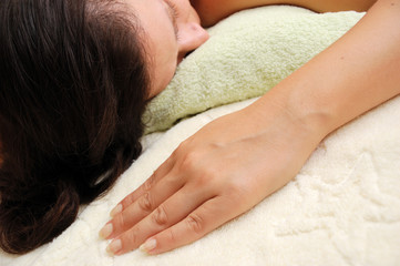 Fototapeta na wymiar concept of spa - pretty female laying over towels