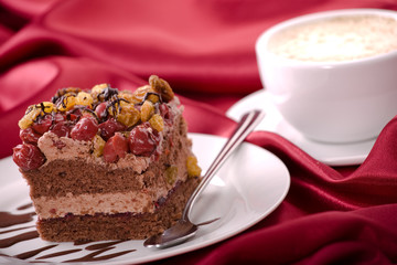 Delicious cream cake with cherry and coffee.