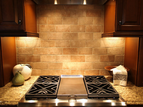 A modern cooktop in a kitchen in an upscale home