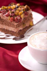 Delicious cream cake with cherry and coffee.