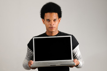 young trendy latino man holding modern laptop computer