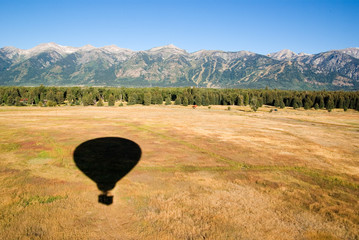 Shadow of a hot air ballooning on the countryside