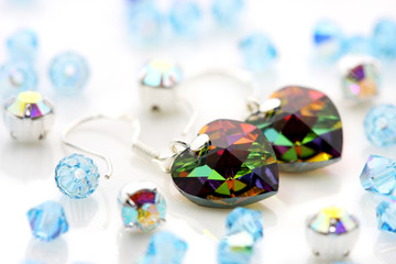 A pair of love shape earrings puts together with beads.