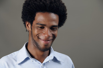 Portrait of young trendy african man with pleased expression