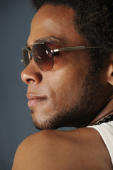 Profile Portrait of young african man wearing sunglasses