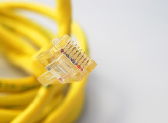 Closeup of internet cable focussed on wires in plug