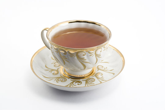a cup of black hot tea over white background
