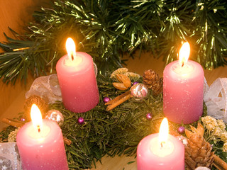 Christmas wreath with violet candles