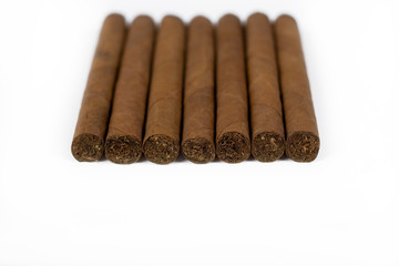 a row of cigars isolated on white