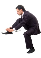 Shoe lacing. Serious businessman sitting