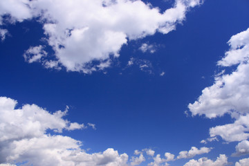 Naklejka na ściany i meble Beautiful white clouds with copyspace on the blue sky