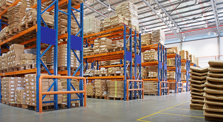 warehouse with multilayer racks in a factory - obrazy, fototapety, plakaty