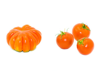 Round small and big red tomatoes on a white background