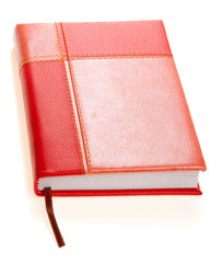 Red-and-orange personal organizer, vertically placed, isolated