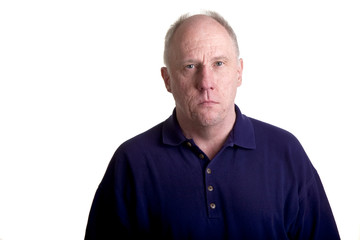 Obraz premium An older bald guy in a blue shirt with a serious expression