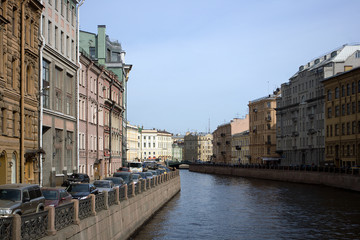 Kind on quay, houses and cars in the center of Petersburg.
