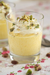 Delicious mango mousse with whipped cream and pistachio nuts