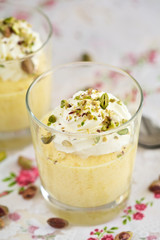 Delicious mango mousse with whipped cream and pistachio nuts
