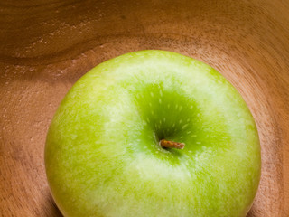 fresh green apple on the wooden plate