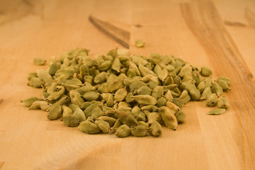Cardamom fruits on wood