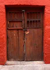 detail of red wall and wood door