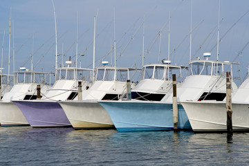 Row of nice deep sea fishing boats in a marina.