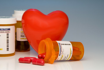 A heart and bottles of prescription medication.