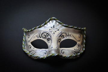 A white Venetian Mask on black background