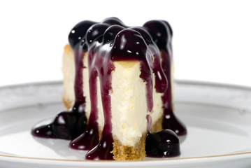 A delicious slice of cheesecake with fruit topping.