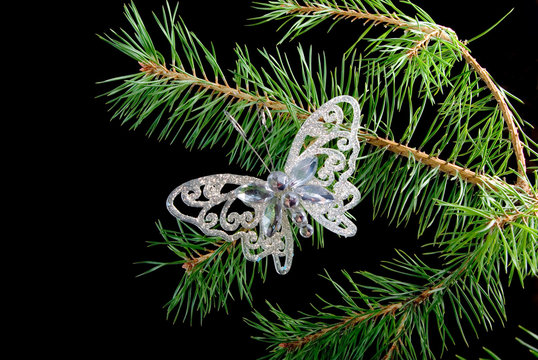 Christmas tree ornaments  on dark background .butterfly