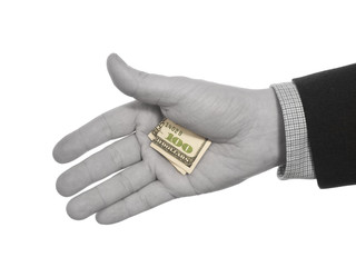 Fototapeta premium A black and white hand hiding a colorful hundred dollars tip.