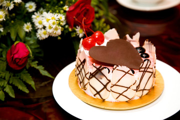 beautiful cake decorated with heart shape chocolate on top