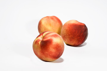 Fototapeta na wymiar three ripe fresh peaches over white background