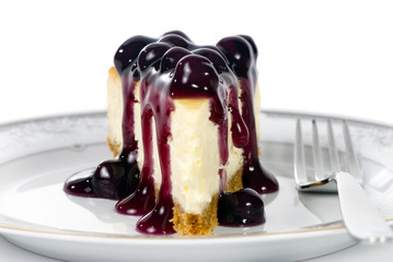 A delicious slice of cheesecake with fruit topping.