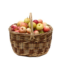 apples in woven basket isolated on white background.