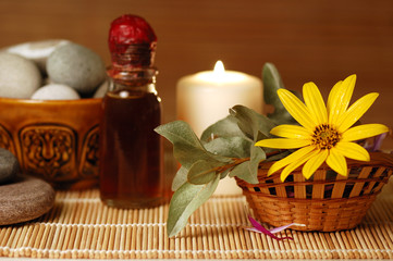 candle, pebble stones, massage oil, flower for spa