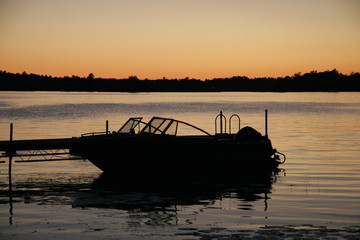 boat docked sunrise shadow