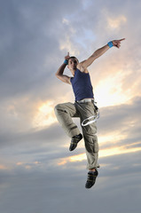 young man dancing and jumping  on top of the building