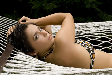 Adult woman in animal print bathing suit posing with her hair