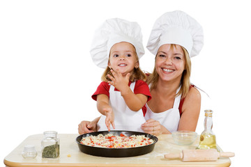 Proud little girl making first pizza with her mother - isolated