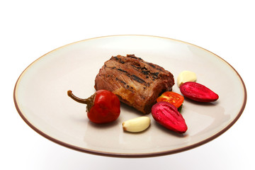 grilled meat on dish over white