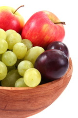 Naklejka na ściany i meble Close up of fresh fruit in wooden bowl