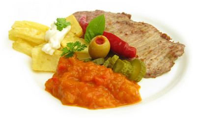 Beef steak with french fries, paprika and olive