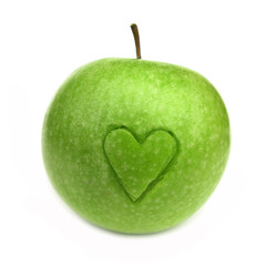 Green apple with carved heart