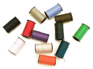 multicolored fiber spools against the white background